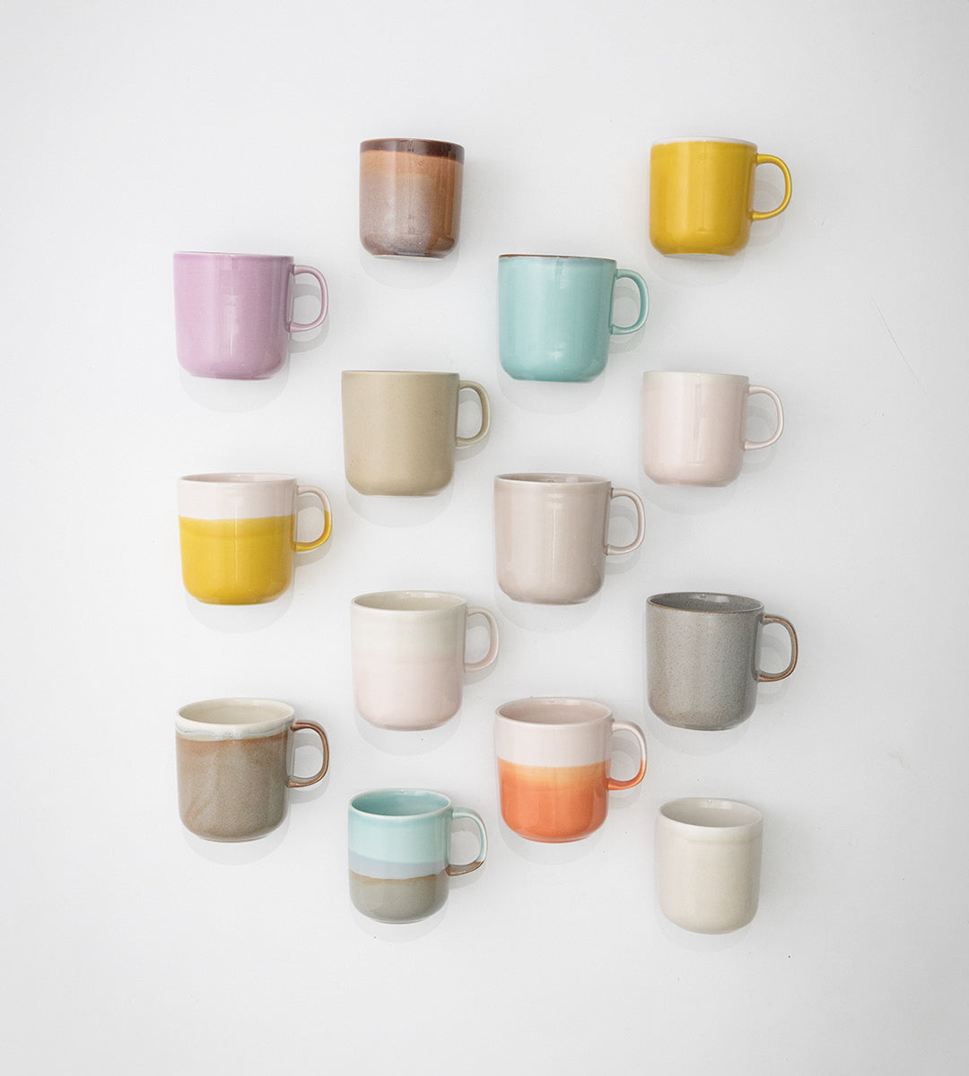 Tuntu mugs in different colors and shapes photographed on white background.